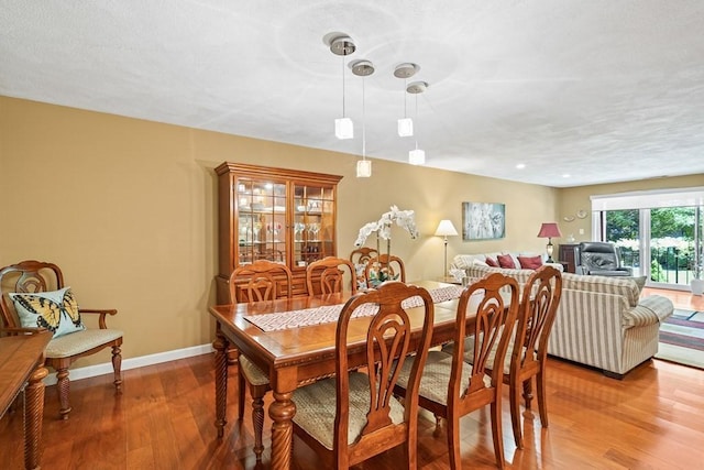 dining space with hardwood / wood-style floors