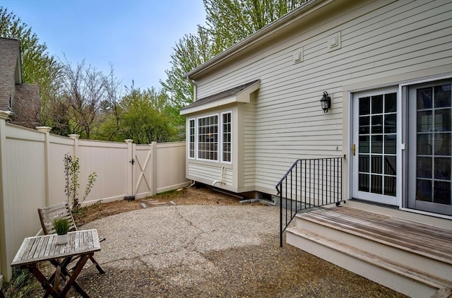 view of patio with fence and a gate
