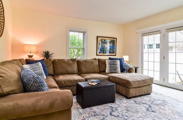 living area with a healthy amount of sunlight and carpet floors