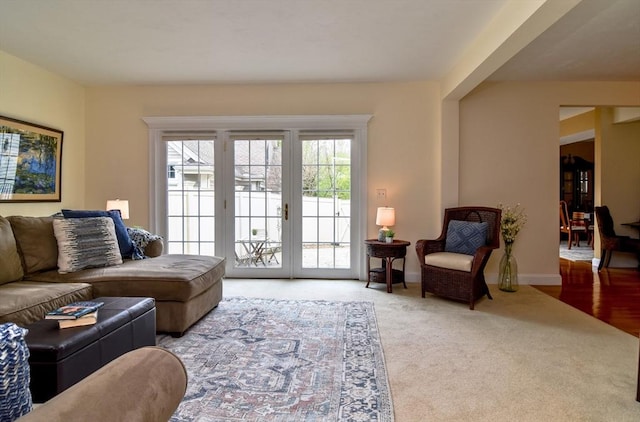 living room with baseboards and carpet flooring