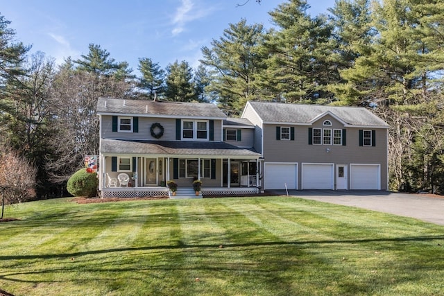 view of front of property with covered porch, a front yard, and a garage