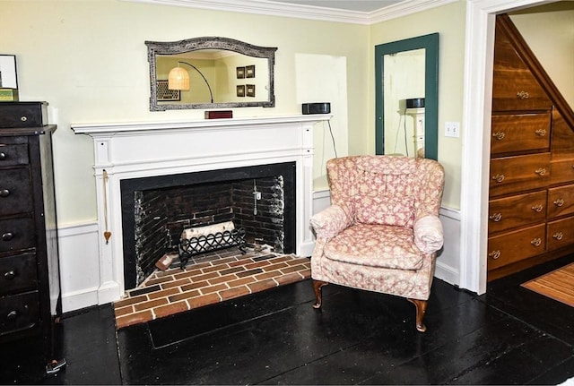 sitting room featuring a brick fireplace and crown molding
