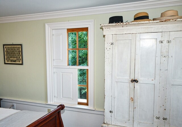 bedroom featuring multiple windows and crown molding