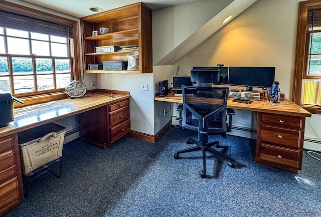 office area featuring built in study area, baseboard heating, and a wealth of natural light