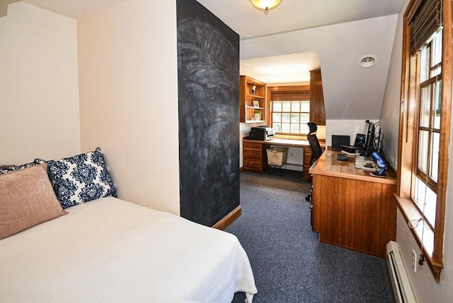 bedroom with dark colored carpet and a baseboard heating unit