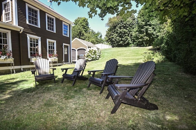 view of yard featuring a garage and fence