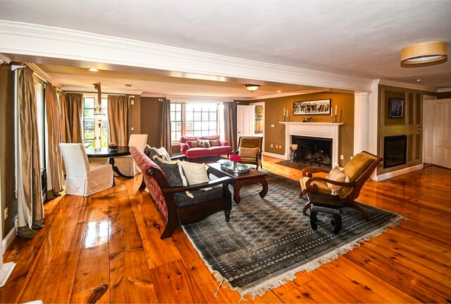 living room with hardwood / wood-style flooring and crown molding