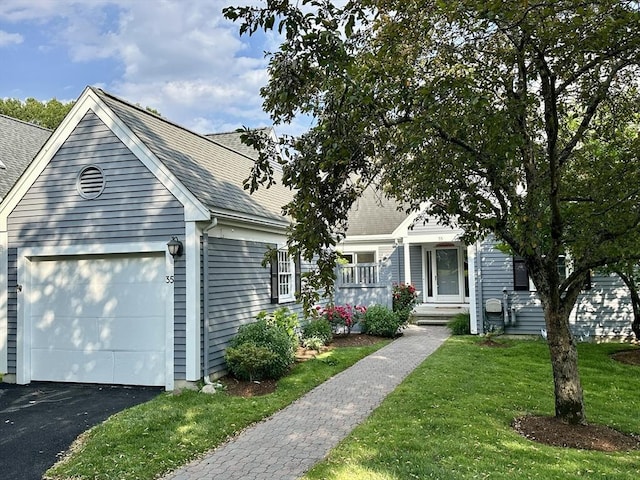 35 Mitchell Grant Way, Bedford, MA 01730 - view of front facade with an attached garage, a front yard, driveway, roof with shingles, and covered porch