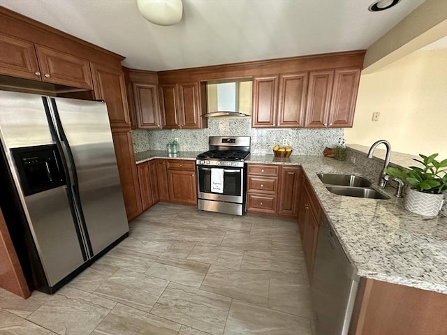 35 Mitchell Grant Way, Bedford, MA 01730 - kitchen with stainless steel appliances, wall chimney exhaust hood, brown cabinetry, light stone counters, and decorative backsplash