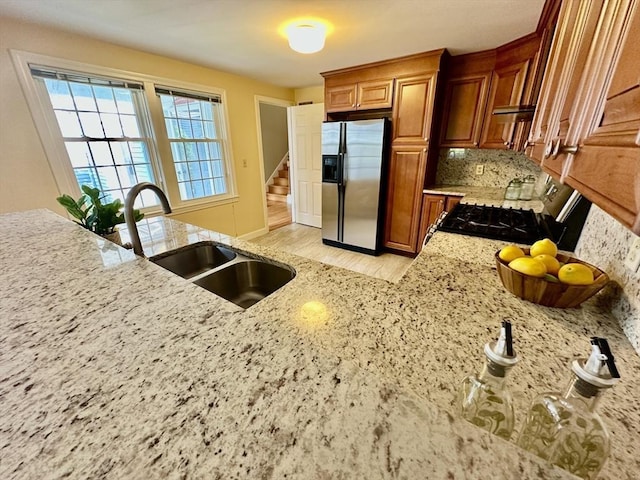 35 Mitchell Grant Way, Bedford, MA 01730 - kitchen with stainless steel fridge, light wood-style floors, backsplash, range with gas cooktop, and brown cabinetry