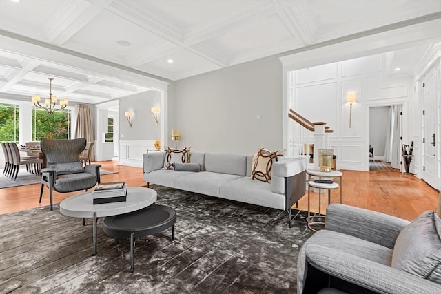 382 Lee St, Brookline, MA 02445 - living area with coffered ceiling, a chandelier, a decorative wall, stairs, and beamed ceiling