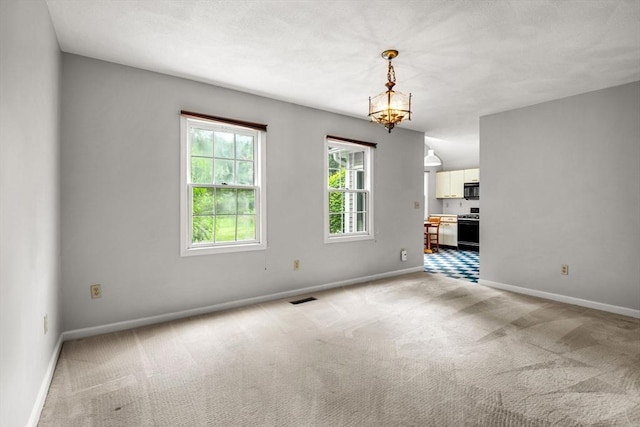 20 Ipswich Woods Dr Unit 20, Ipswich, MA 01938 - unfurnished dining area featuring light carpet, baseboards, and a chandelier