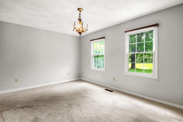 20 Ipswich Woods Dr Unit 20, Ipswich, MA 01938 - spare room featuring baseboards, carpet flooring, and a chandelier