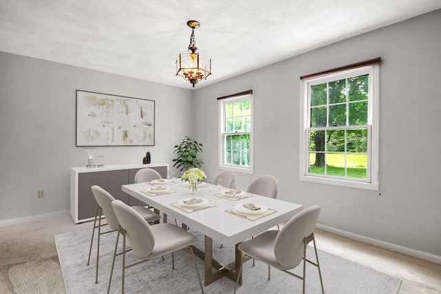 20 Ipswich Woods Dr Unit 20, Ipswich, MA 01938 - dining room featuring light colored carpet, baseboards, and a chandelier
