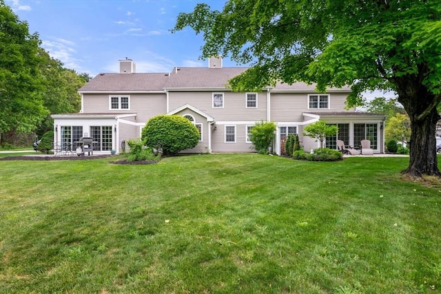 20 Ipswich Woods Dr Unit 20, Ipswich, MA 01938 - rear view of house with a patio area, a yard, and a chimney