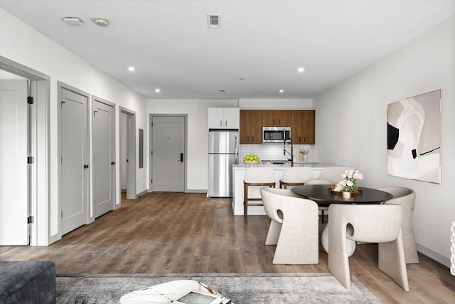 dining space featuring hardwood / wood-style flooring