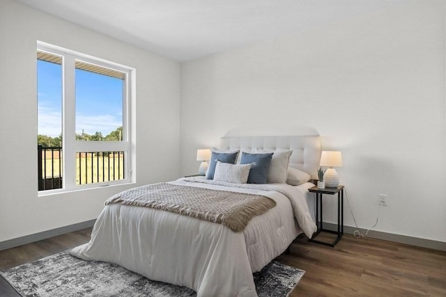 bedroom with dark hardwood / wood-style floors