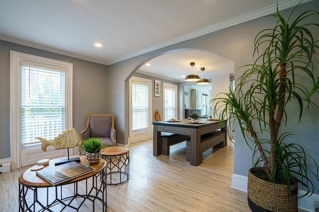 362 Commercial St, Braintree, MA 02184 - dining room featuring arched walkways, light wood finished floors, plenty of natural light, baseboards, and crown molding