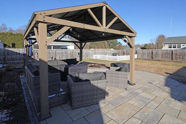 view of patio with a gazebo, outdoor lounge area, and a fenced backyard