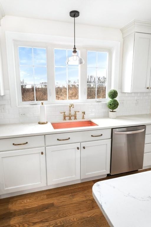 kitchen featuring dark wood-type flooring, a sink, backsplash, white cabinets, and dishwasher