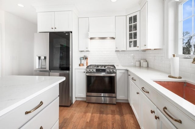 kitchen featuring white cabinetry, light wood-style floors, light stone countertops, and stainless steel appliances