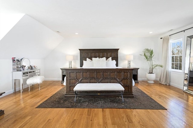 bedroom featuring baseboards and wood finished floors