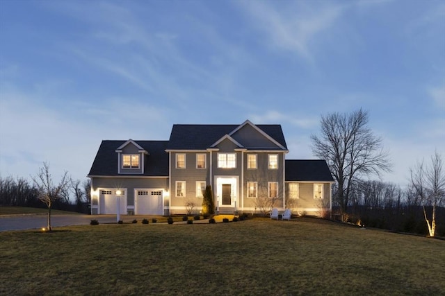 view of front of home featuring a garage, driveway, and a front yard