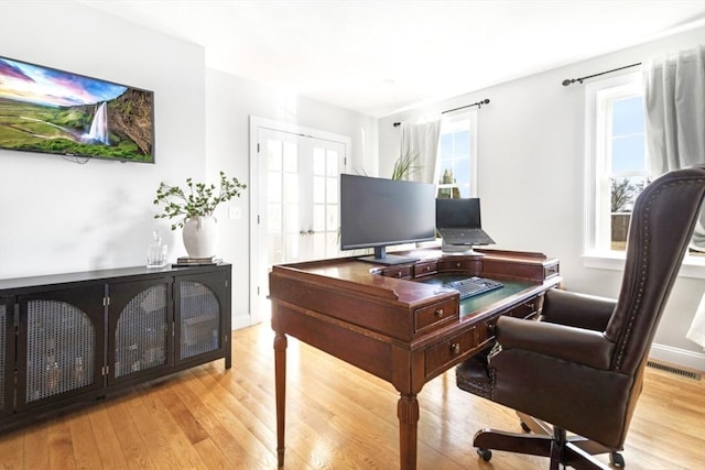 office featuring visible vents, french doors, and light wood-style floors