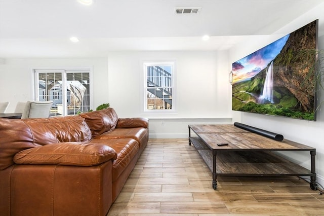 living room with visible vents, recessed lighting, baseboards, and wood tiled floor