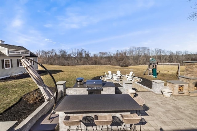 view of patio / terrace with area for grilling and playground community