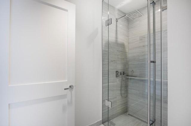 bathroom featuring a shower with door