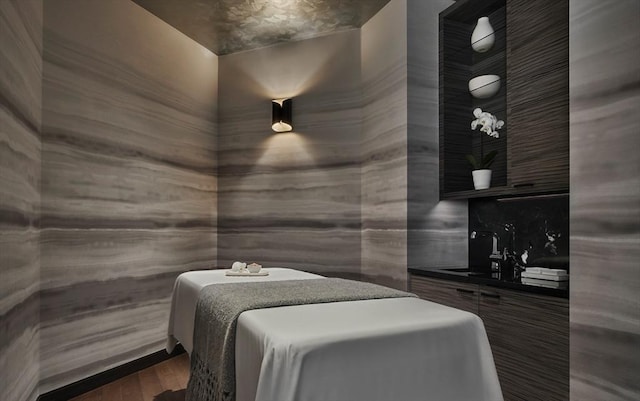 bedroom featuring dark hardwood / wood-style flooring and sink