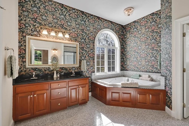 full bathroom with a sink, double vanity, wallpapered walls, and a bath