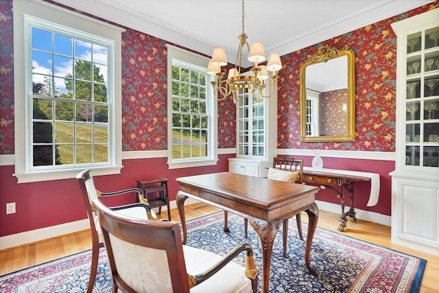 home office featuring wallpapered walls, a notable chandelier, and wood finished floors