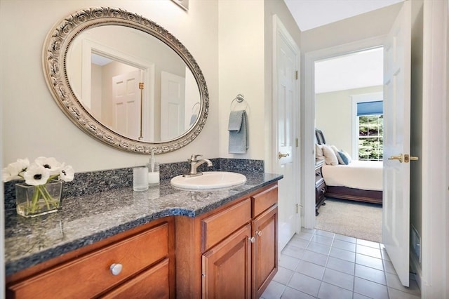 ensuite bathroom featuring ensuite bathroom, tile patterned flooring, and vanity