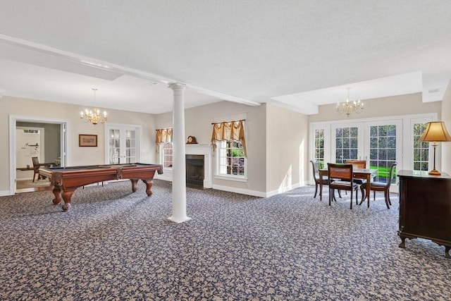 rec room featuring carpet floors, baseboards, an inviting chandelier, and a wealth of natural light