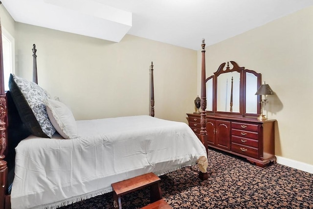 carpeted bedroom featuring baseboards