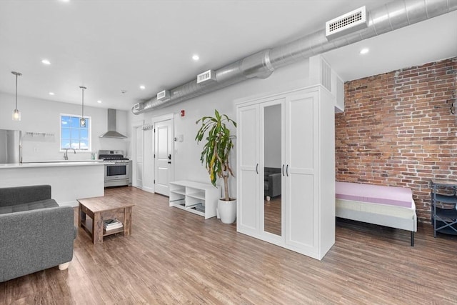 103-105 Broadway, Chelsea, MA 02150 - living room featuring light wood-type flooring and recessed lighting