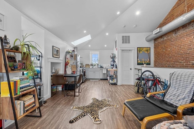 103-105 Broadway, Chelsea, MA 02150 - living area with a skylight, high vaulted ceiling, and light wood-type flooring