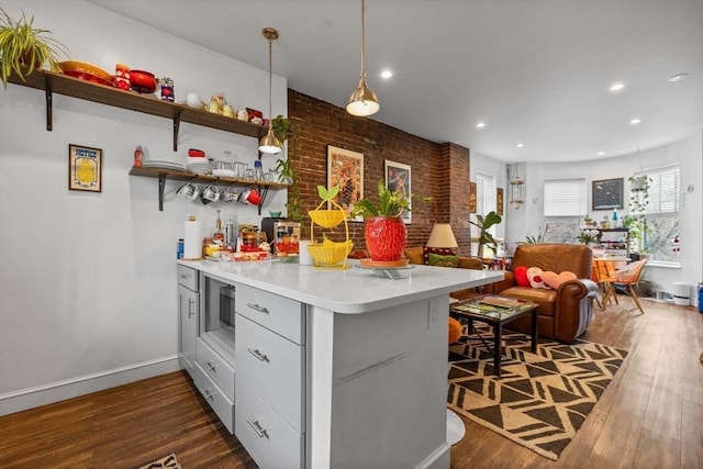 103-105 Broadway, Chelsea, MA 02150 - kitchen with a peninsula, dark wood-style floors, light countertops, stainless steel microwave, and recessed lighting