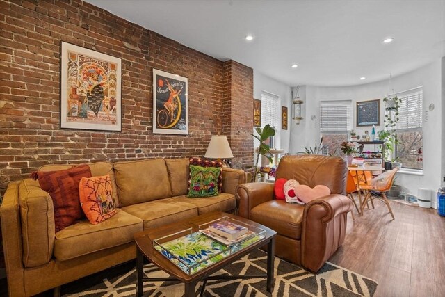 103-105 Broadway, Chelsea, MA 02150 - living area featuring wood finished floors, brick wall, and recessed lighting