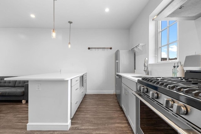 103-105 Broadway, Chelsea, MA 02150 - kitchen featuring stainless steel appliances, a sink, a peninsula, ventilation hood, and light countertops