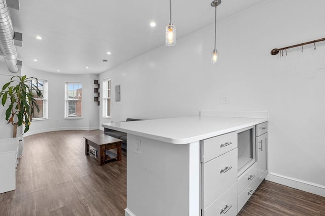 103-105 Broadway, Chelsea, MA 02150 - kitchen with dark wood-style floors, recessed lighting, light countertops, hanging light fixtures, and baseboards