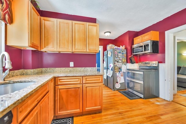 15 W St, Paxton, MA 01612 - kitchen featuring stainless steel appliances, light wood finished floors, and light stone counters