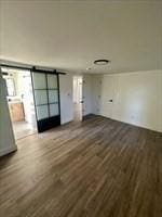 interior space featuring a barn door and dark hardwood / wood-style flooring