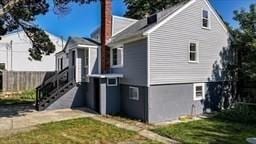 view of side of home featuring a yard