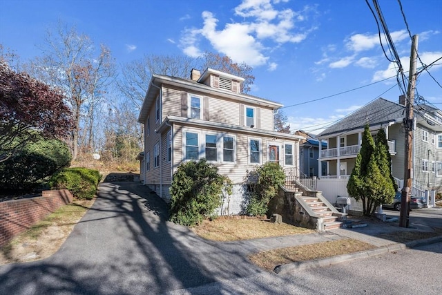 american foursquare style home featuring a chimney