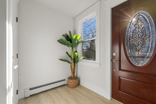 entryway featuring baseboards, baseboard heating, and light wood-style flooring