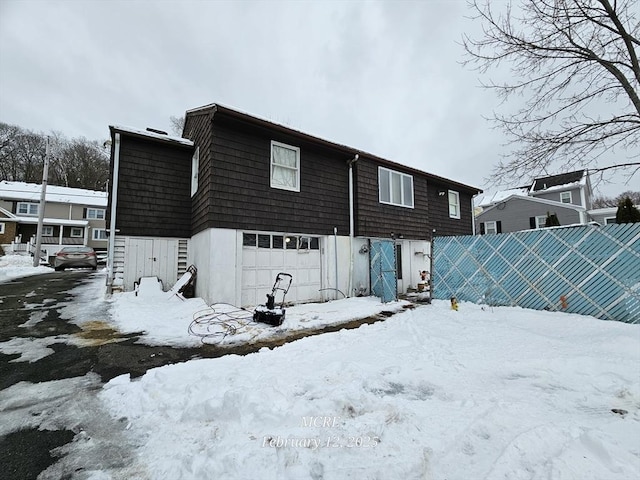 view of snow covered back of property