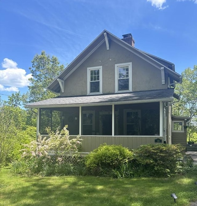 19 Aldena Rd, Worcester, MA 01603 - view of property exterior featuring a chimney, a lawn, stucco siding, and a sunroom